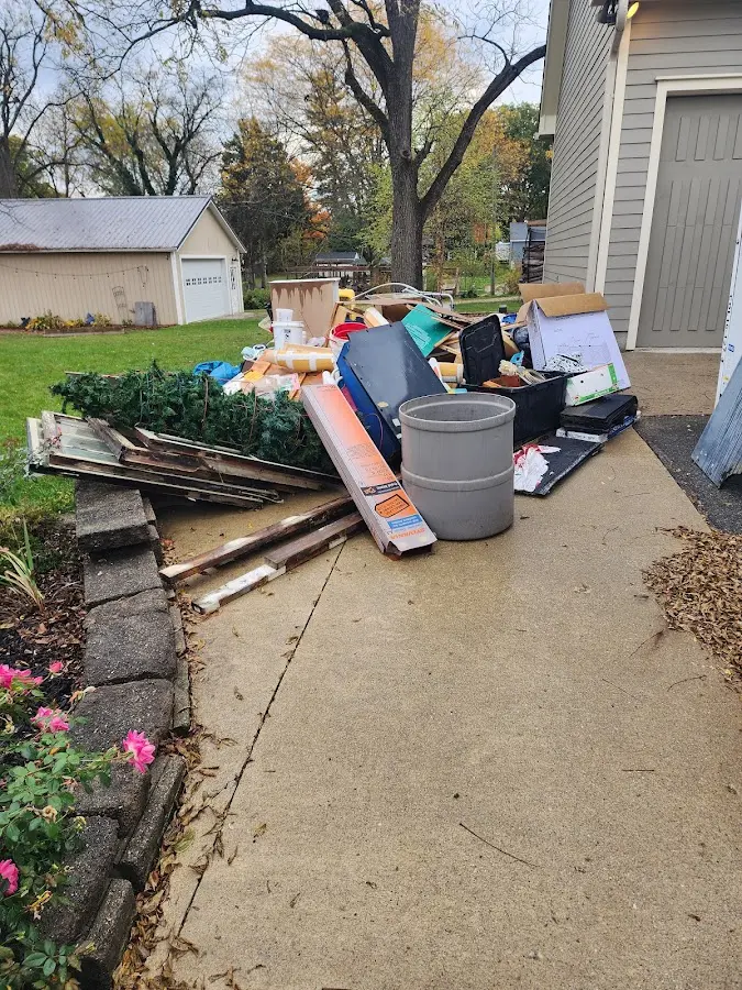 Dumpster being loaded with debris for Estate Cleanout Dumpster Rental in Rock Springs